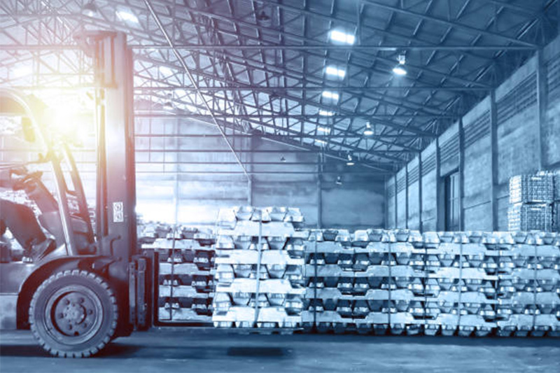 Forklift handling pack of aluminum ingot in warehou